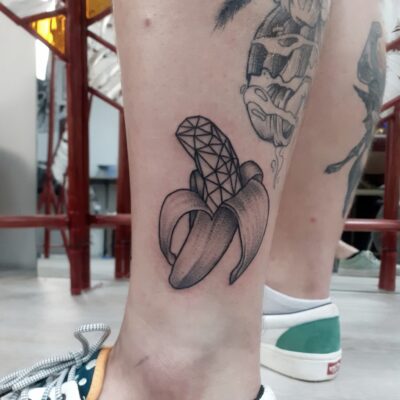 banana tattoo, geometric tattoo, leg tattoo, light art tattoo, women tattooer